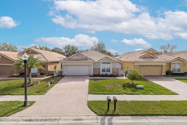 single story home with a garage and a front lawn