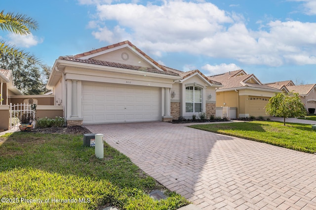 view of front of property featuring a garage and a front lawn