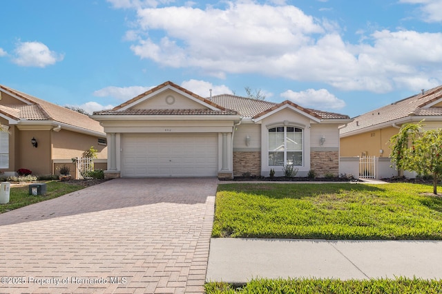 mediterranean / spanish house featuring a garage and a front lawn