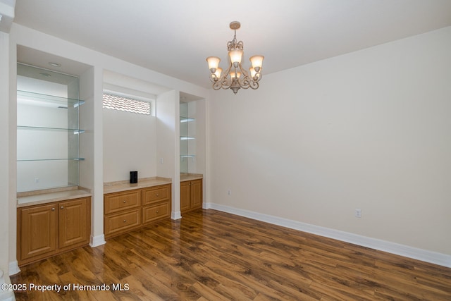 interior space with dark hardwood / wood-style floors and a notable chandelier