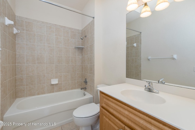 full bathroom featuring vanity, tiled shower / bath combo, and toilet