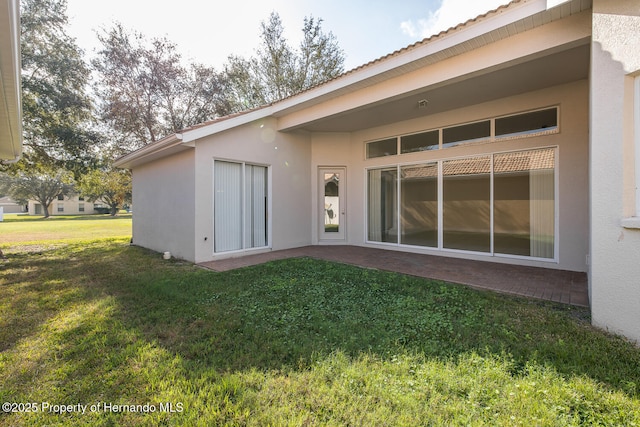 rear view of property featuring a yard