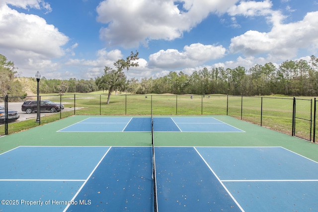 view of sport court featuring a yard and basketball court