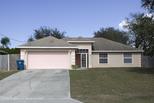 single story home with an attached garage, fence, driveway, stucco siding, and a front yard