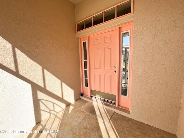 entrance to property featuring stucco siding