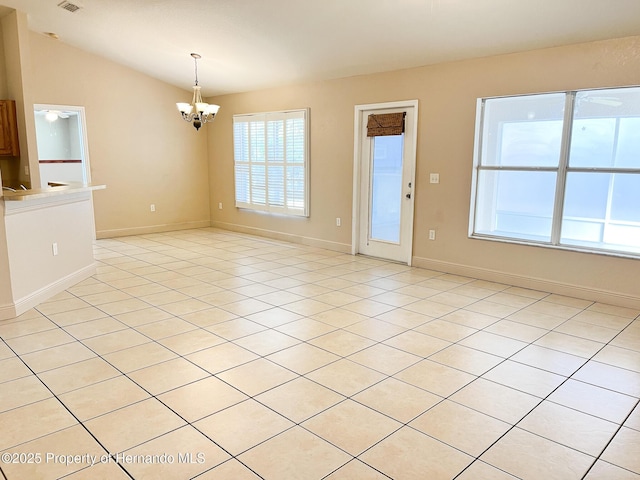 spare room with a chandelier, light tile patterned floors, visible vents, baseboards, and vaulted ceiling