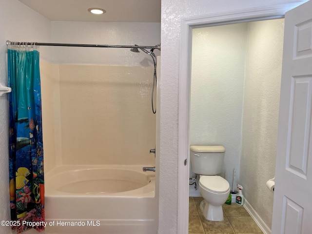 full bathroom with a textured wall, tile patterned flooring, toilet, baseboards, and shower / bathtub combination with curtain