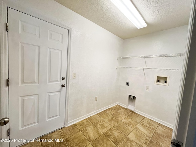 clothes washing area with laundry area, baseboards, a textured ceiling, washer hookup, and electric dryer hookup