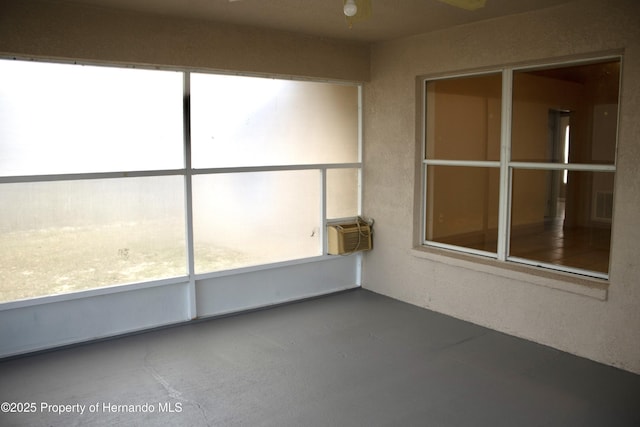 unfurnished sunroom with visible vents and a wall mounted AC