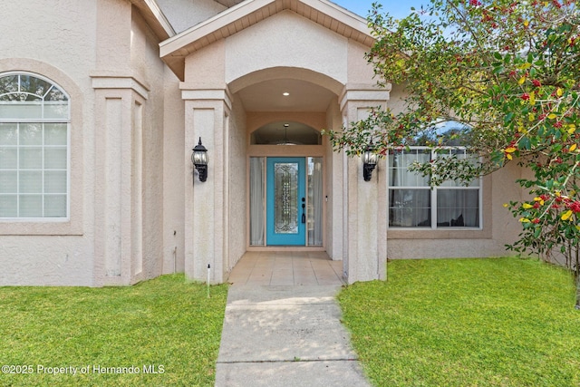 property entrance featuring a lawn