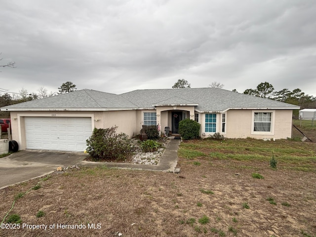 single story home with a garage and a front lawn