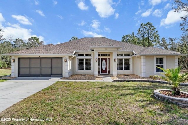 view of front of property with a front yard and a garage