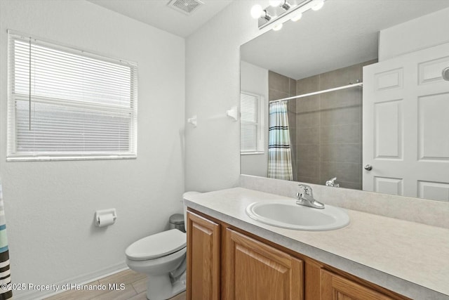 bathroom featuring a shower with curtain, hardwood / wood-style flooring, vanity, and toilet