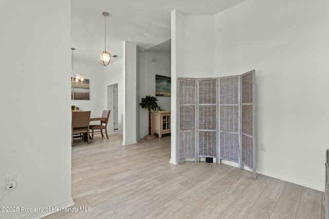 unfurnished room featuring light hardwood / wood-style flooring and a high ceiling