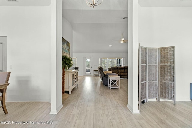 foyer entrance with high vaulted ceiling, ceiling fan, and light hardwood / wood-style flooring