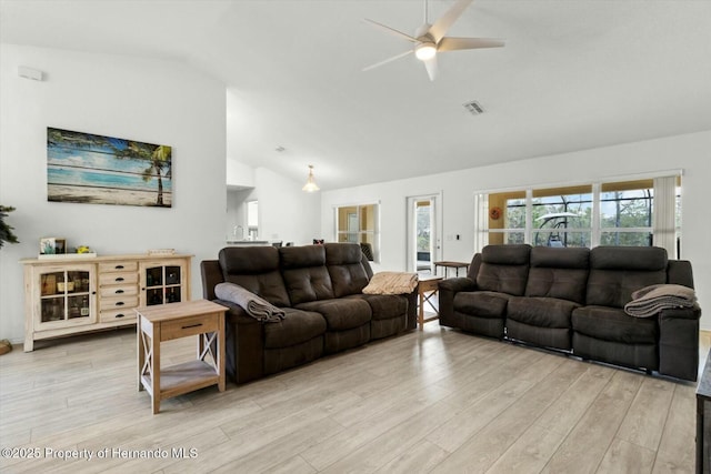 living room featuring ceiling fan, light hardwood / wood-style flooring, and high vaulted ceiling