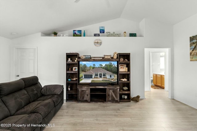 living room with lofted ceiling and light hardwood / wood-style flooring