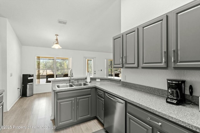 kitchen featuring stainless steel dishwasher, sink, gray cabinetry, and kitchen peninsula