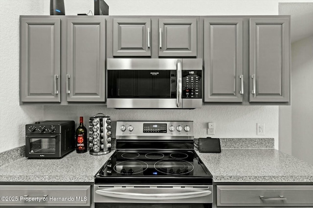 kitchen featuring gray cabinets and stainless steel appliances