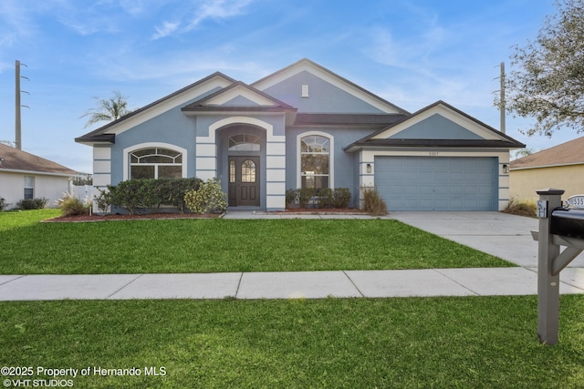 ranch-style house with a front lawn and a garage