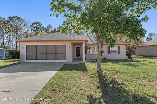 ranch-style home featuring stucco siding, an attached garage, concrete driveway, and a front yard