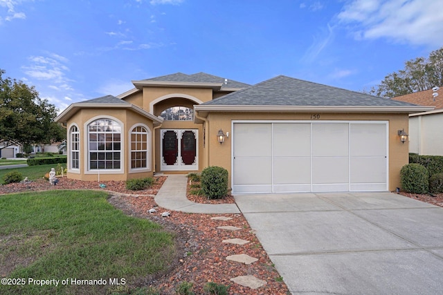 view of front of home featuring a front yard and a garage