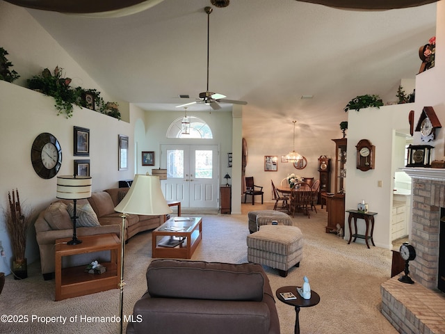 living area featuring carpet floors, french doors, a fireplace, a high ceiling, and ceiling fan