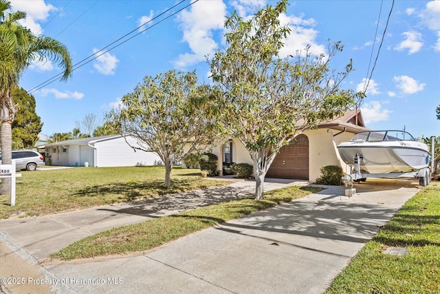 view of front of house featuring a front yard and a garage