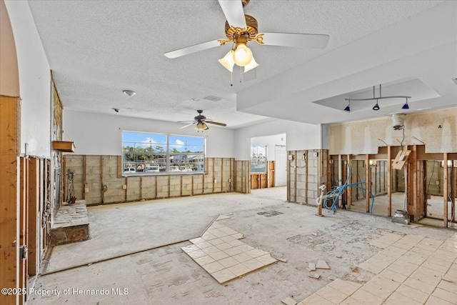 miscellaneous room with a textured ceiling and ceiling fan