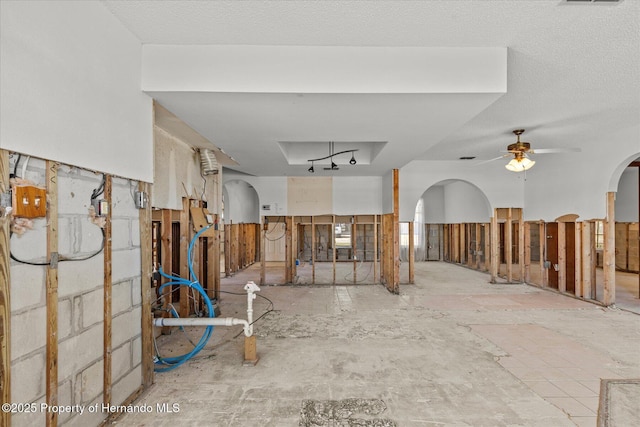 interior space featuring a textured ceiling and ceiling fan