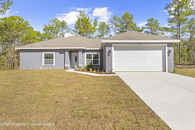 ranch-style home featuring a front lawn and a garage