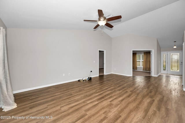 unfurnished living room featuring baseboards, wood finished floors, ceiling fan, and vaulted ceiling