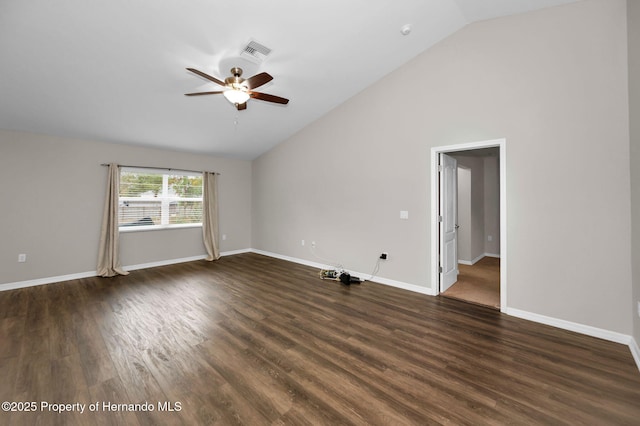 spare room with dark wood-style floors, visible vents, a ceiling fan, and vaulted ceiling