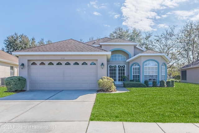 single story home featuring a garage and a front yard