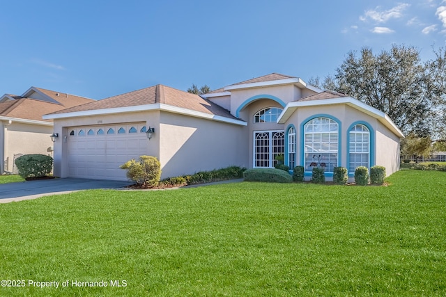 view of front of house with a garage and a front yard