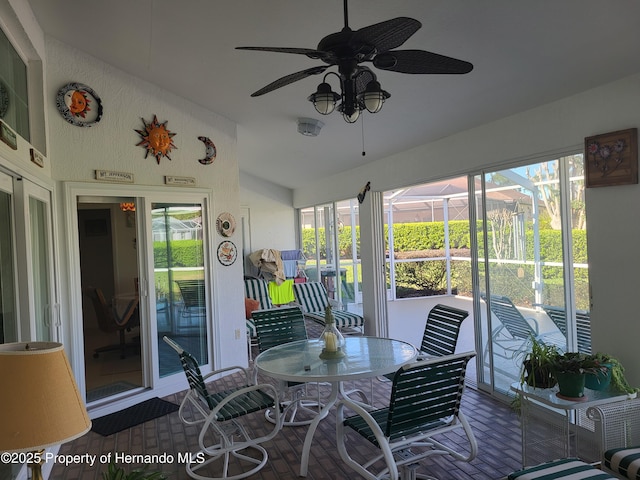 sunroom with lofted ceiling and ceiling fan