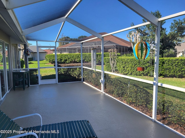 unfurnished sunroom featuring lofted ceiling