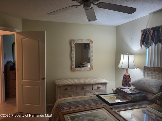 bedroom featuring a ceiling fan and a textured ceiling