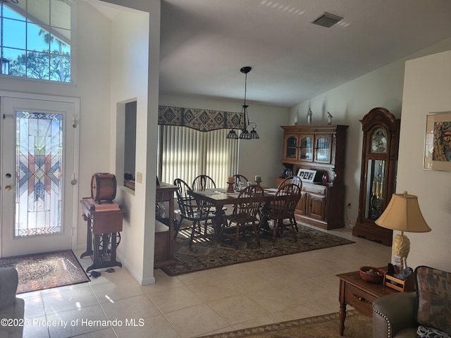 dining space featuring a wealth of natural light, visible vents, a notable chandelier, and light tile patterned floors