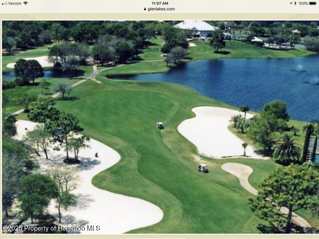 view of home's community with a water view and golf course view