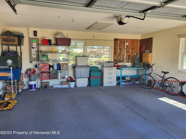 garage with a textured wall and a garage door opener