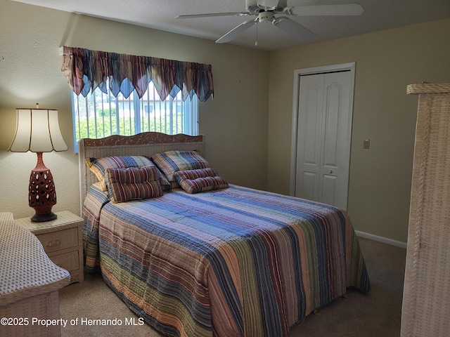 carpeted bedroom with ceiling fan, baseboards, and a closet