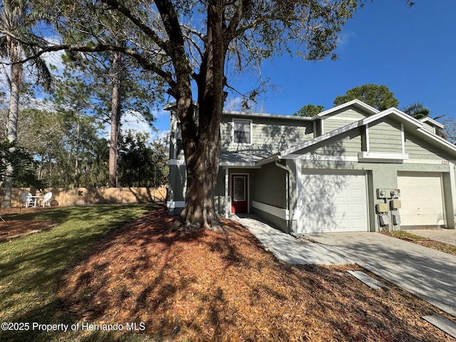 view of property featuring a front lawn and a garage