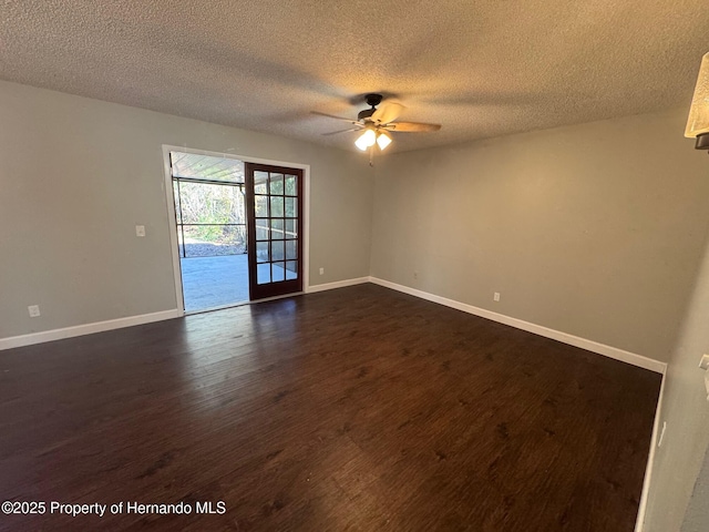 spare room with a textured ceiling, dark hardwood / wood-style floors, and ceiling fan