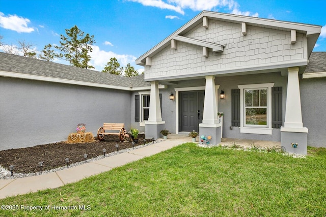 exterior space with roof with shingles, stucco siding, and a lawn