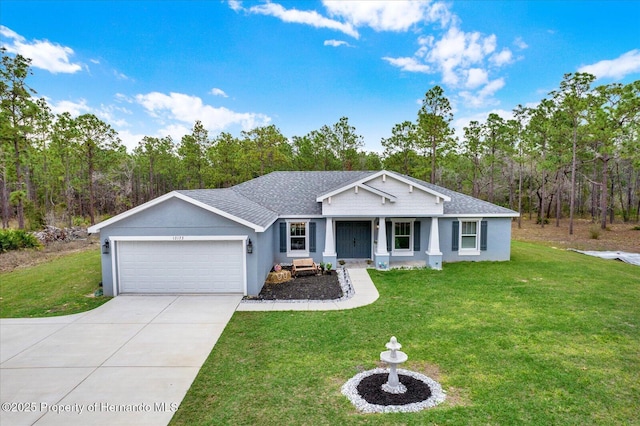 view of front of property featuring roof with shingles, a front lawn, driveway, and an attached garage