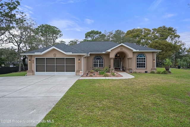 single story home featuring driveway, roof with shingles, an attached garage, a front lawn, and stucco siding