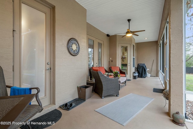 sunroom with ceiling fan and french doors