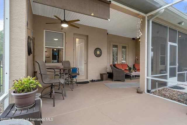 view of patio with outdoor lounge area and ceiling fan