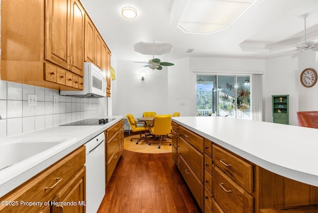 kitchen with brown cabinetry, white appliances, light countertops, and ceiling fan